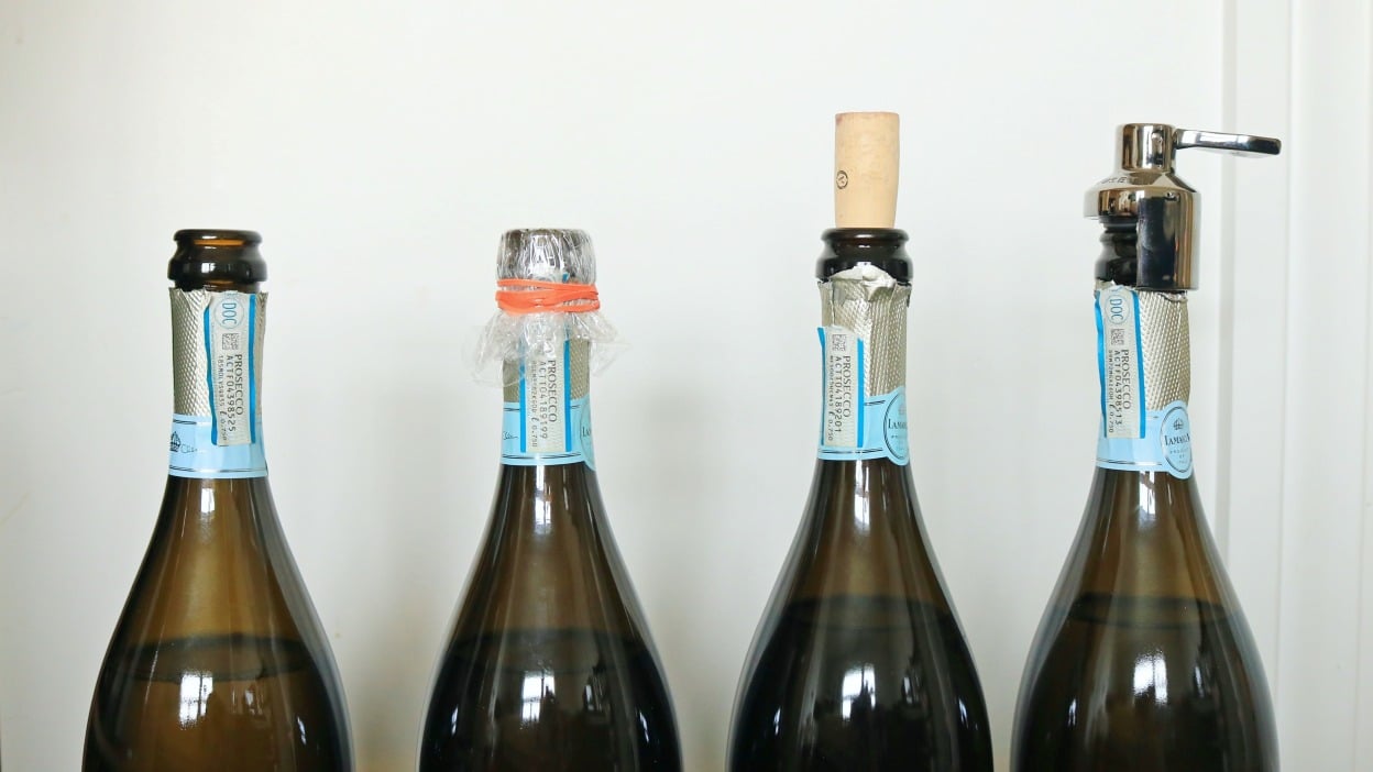 Four bottles of prosecco with different seals.