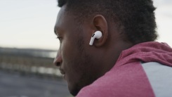 man listening to airpods