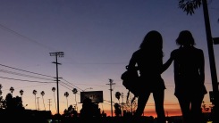 A screenshot of two characters silhouetted against an LA sunset, from Tangerine