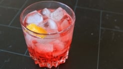 A low ABV red drink with ice.
