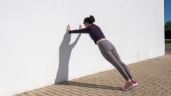 Woman doing wall push-up