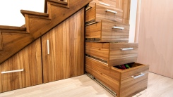 Pullout cabinets on glides in slots under stairs