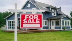 for sale sign in front of house