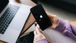 iphone updating in front of a mac