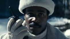 Mr. Milchick holding a walkie talkie in a Severance screenshot