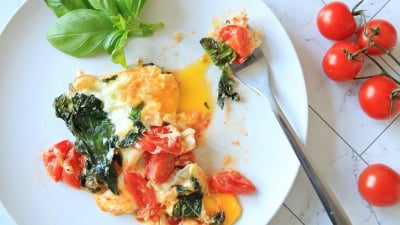 Caprese fried eggs on a plate.