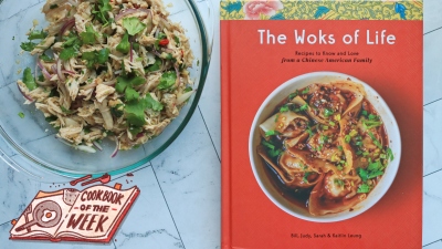 The Woks of Life cookbook next to a bowl of shredded chicken salad.