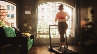 person exercising on treadmill in their apartment