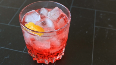 A low ABV red drink with ice.