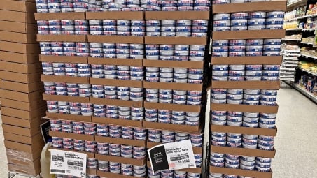 A giant stack display of canned tuna at the grocery store.