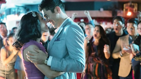 Characters kiss in a still from Crazy Rich Asians/Warner Bros.