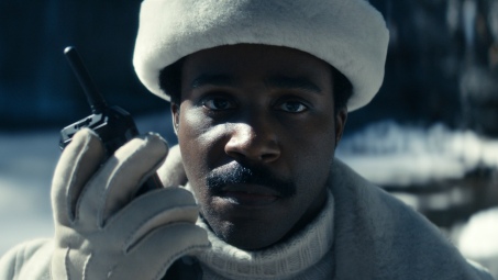 Mr. Milchick holding a walkie talkie in a Severance screenshot