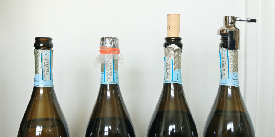 Four bottles of prosecco with different seals.