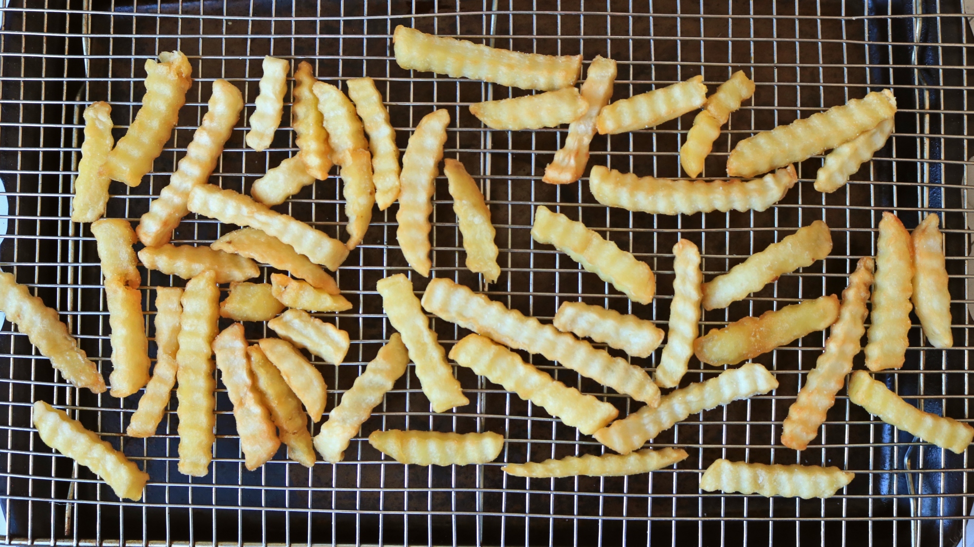 French fries on a wire rack.
