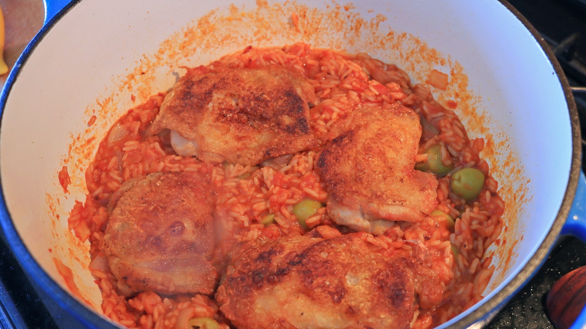 Chicken and tomato-y rice in a pot.