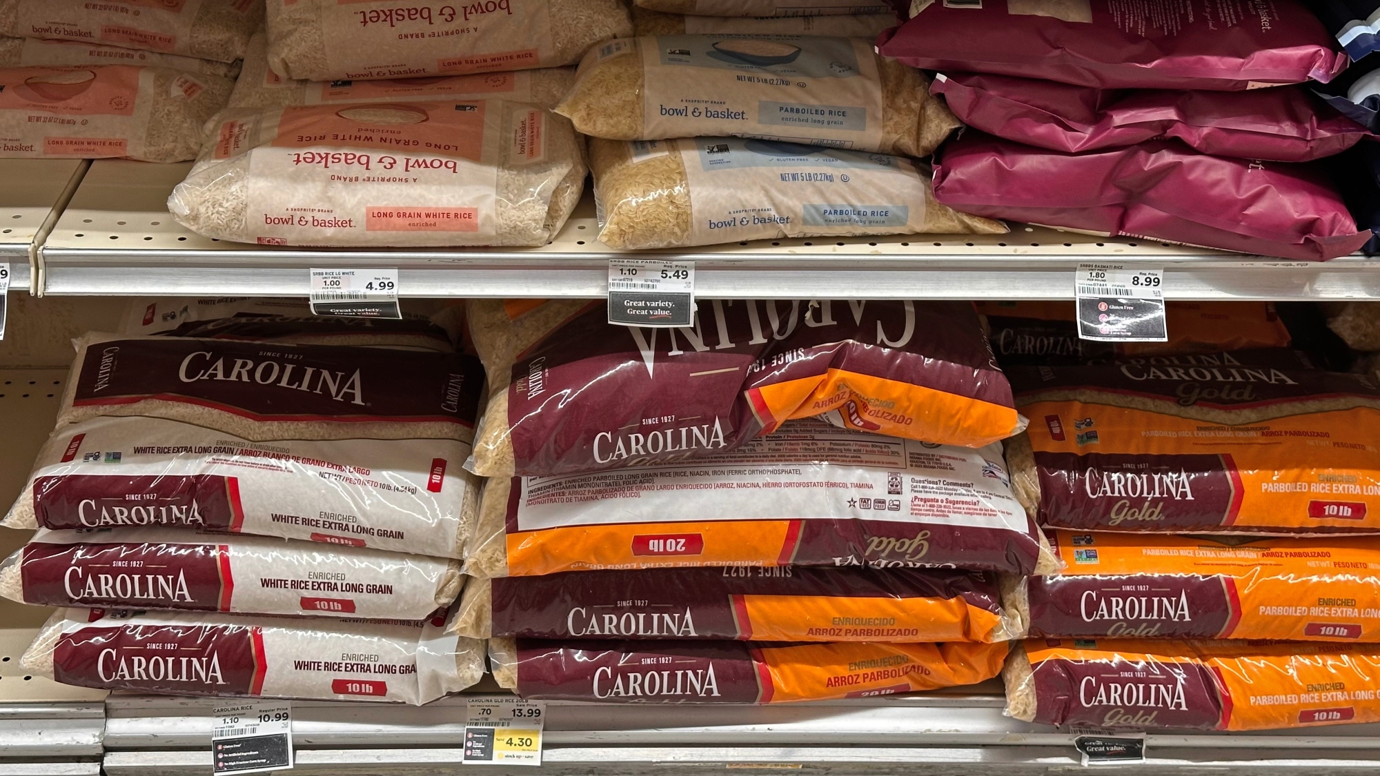 Bags of rice stacked on a grocery shelf