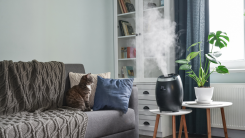 A humidifier emitting a cloud of steam in a home's living room