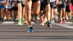 Waist-down view of a group of runners during a marathon