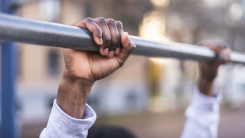 Hands holding onto a pullup bar