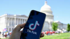 TikTok displayed on a mobile phone screen in front of The White House in Washington DC,