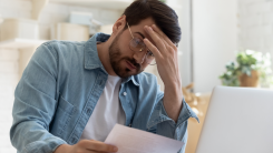 Upset frustrated young man in front of laptop