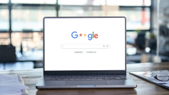 Laptop with modified Google home search page showing the Google logo with censored letters