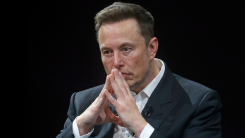 Elon Musk looking pensive with fingers tented