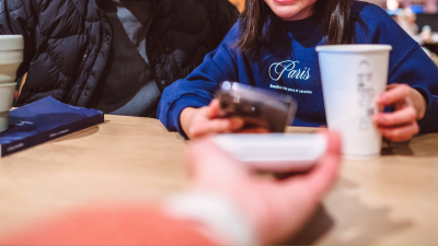 Child using tap to pay on a smartphone