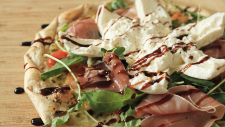 Close-up shot of a pizza with burrata on top.
