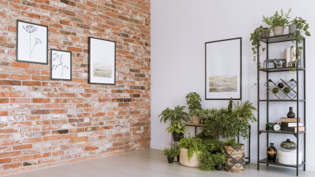 A brick wall with art on it in a contemporary home