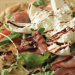 Close-up shot of a pizza with burrata on top.