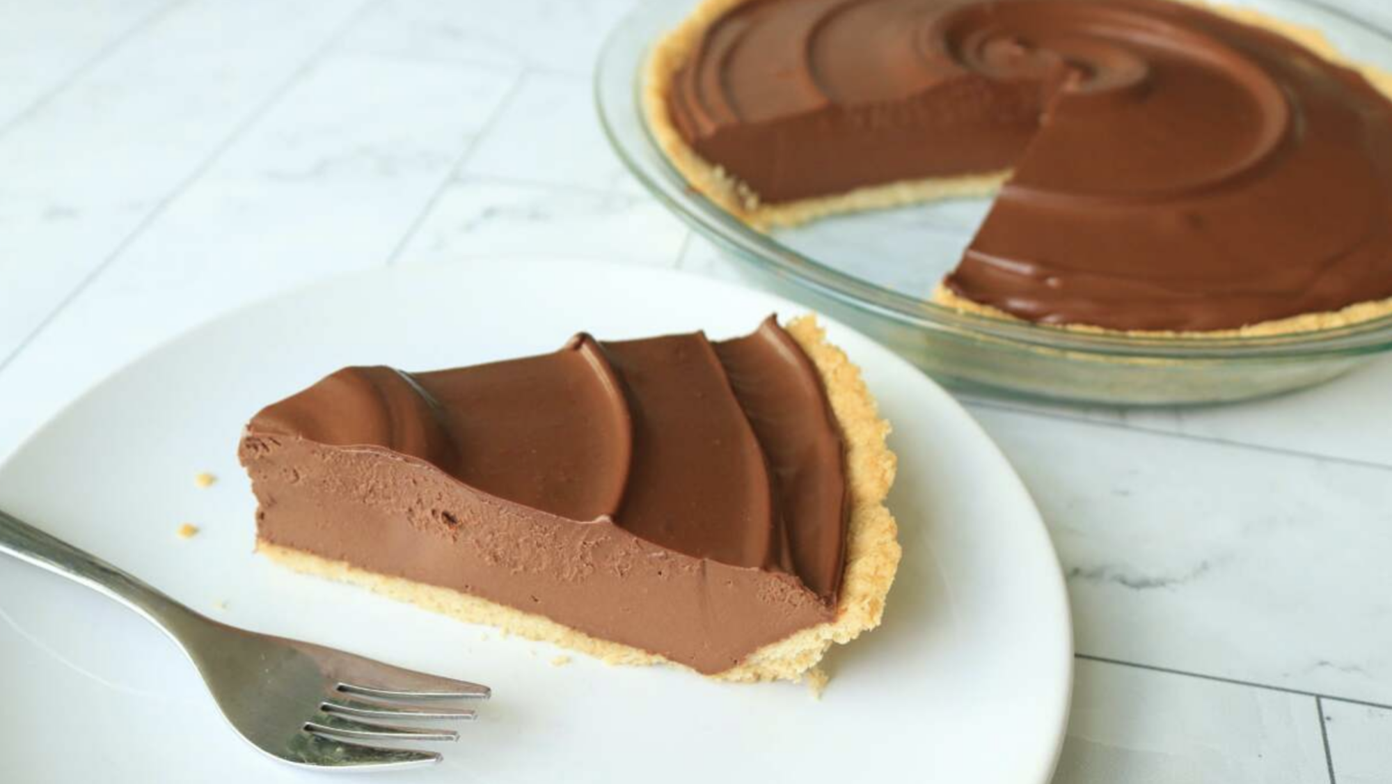 A slice of chocolate pudding pie on a white plate.