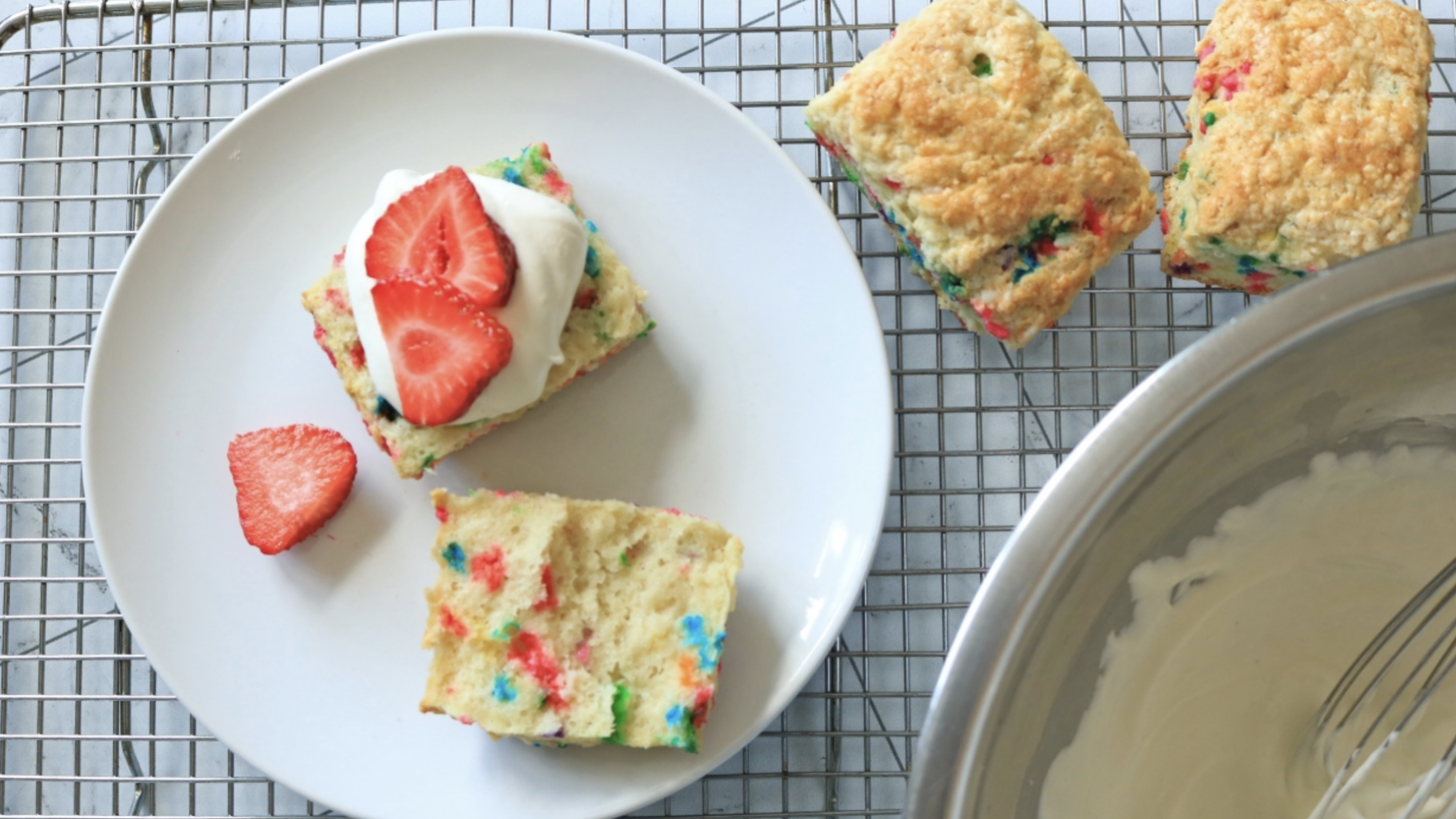 A strawberry short cake with colorful confetti biscuits.